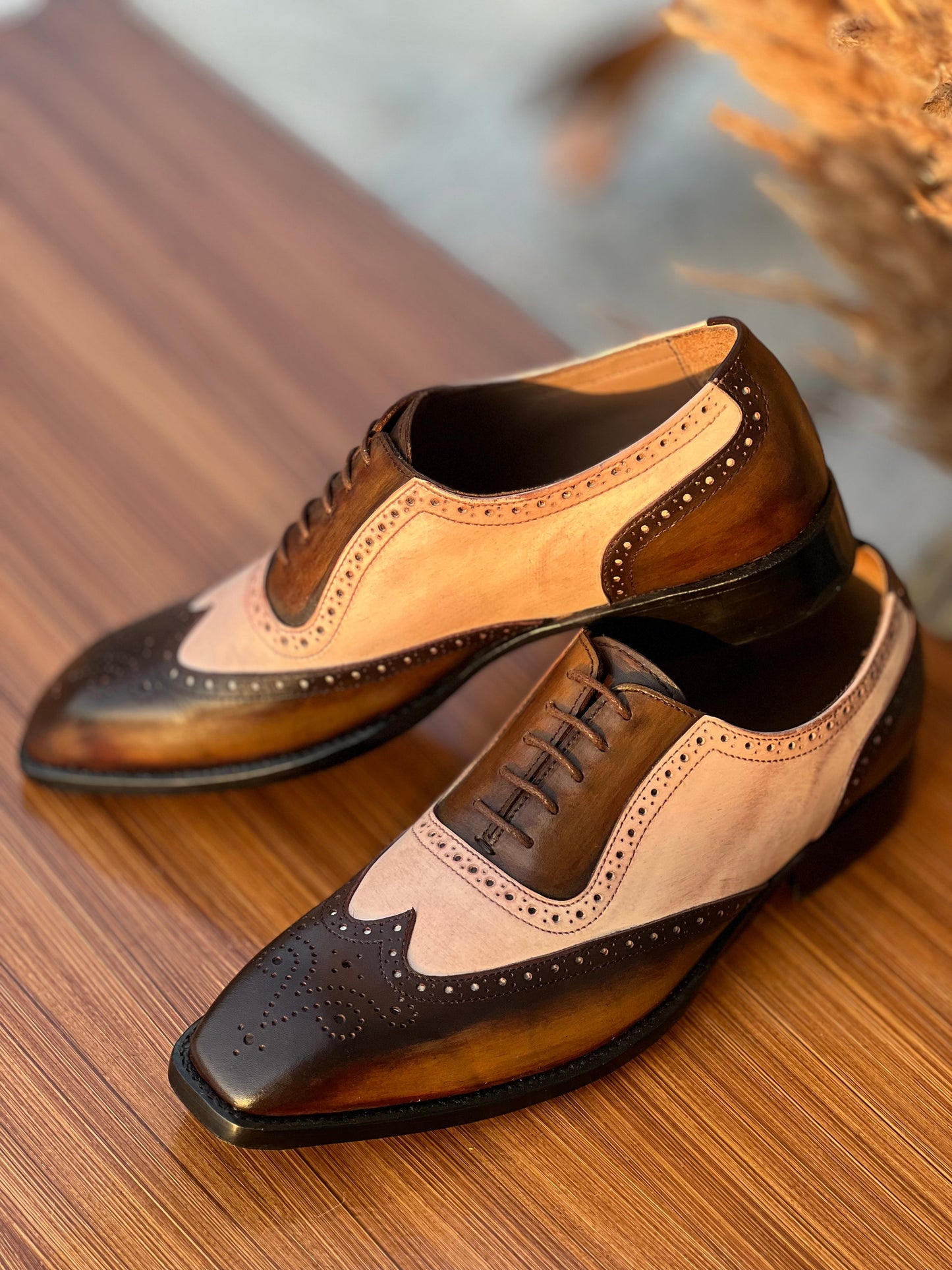Side View of Oxford Wingtip Spectators Patina Detailing on wooden table